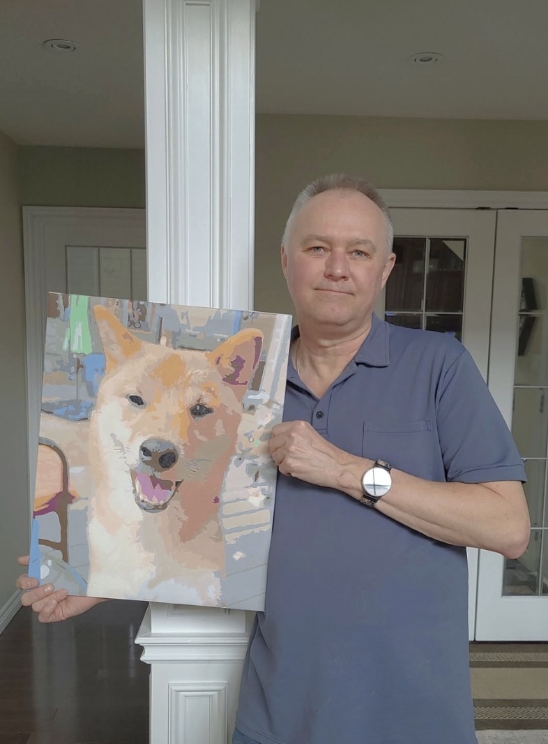 Creator holding finished painting