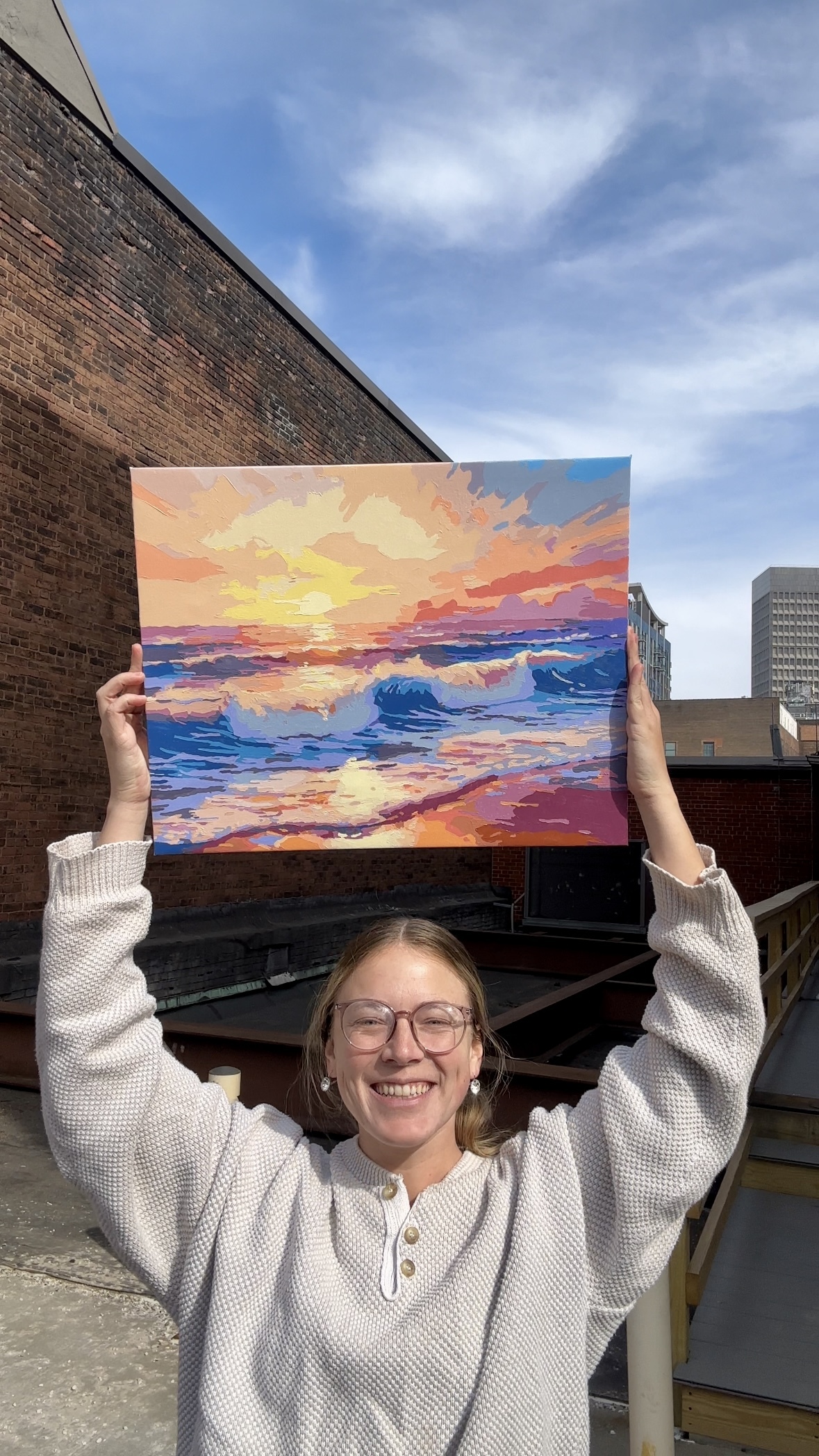 Creator holding finished painting