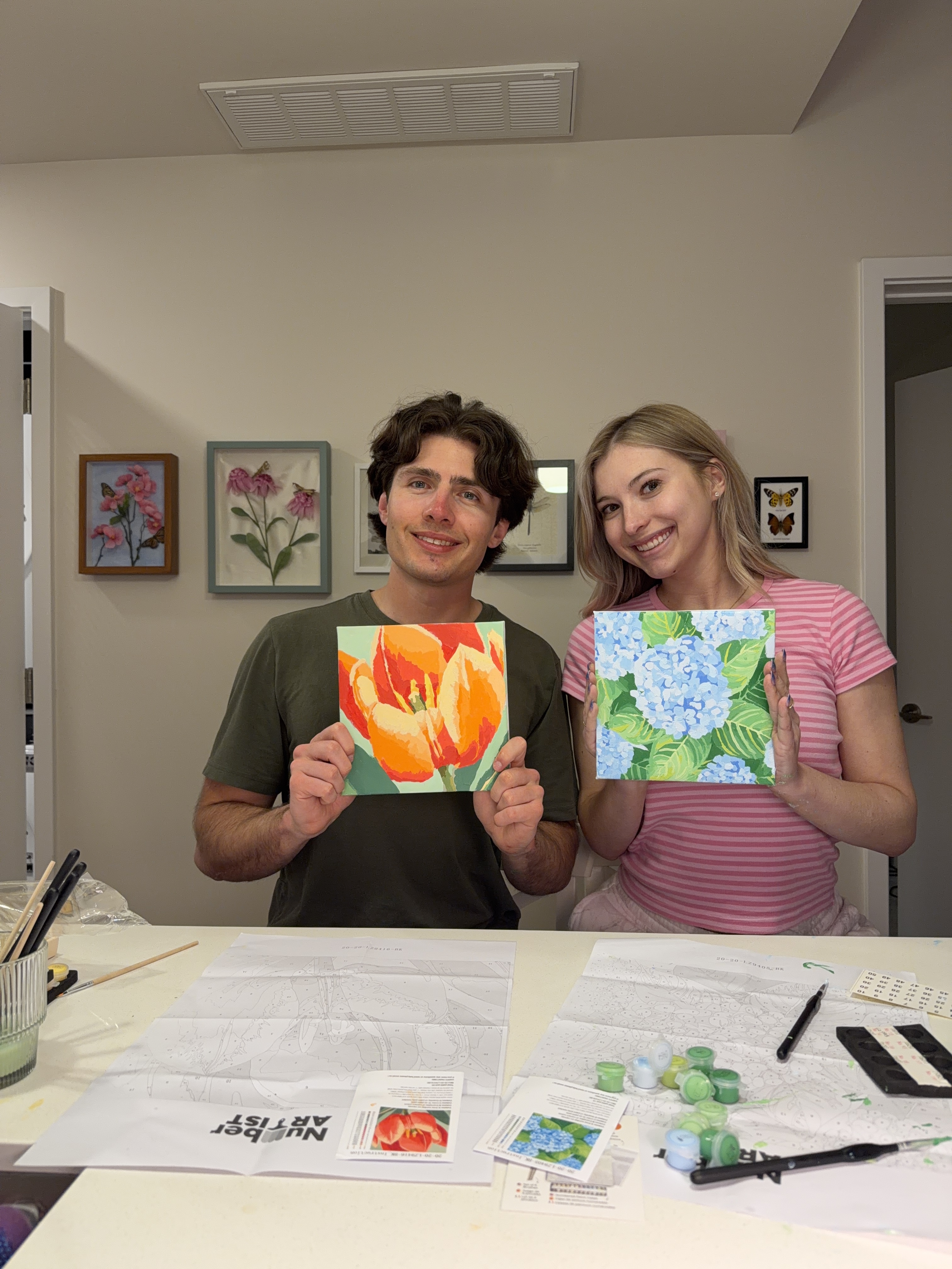 Creators holding finished paintings